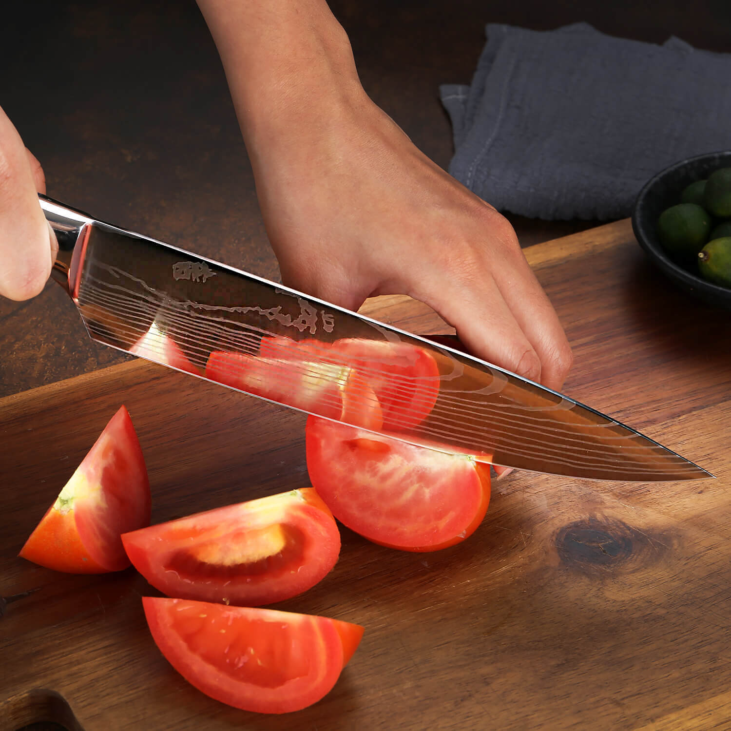 Damascus Pattern Chef Knife Cutting Tomato