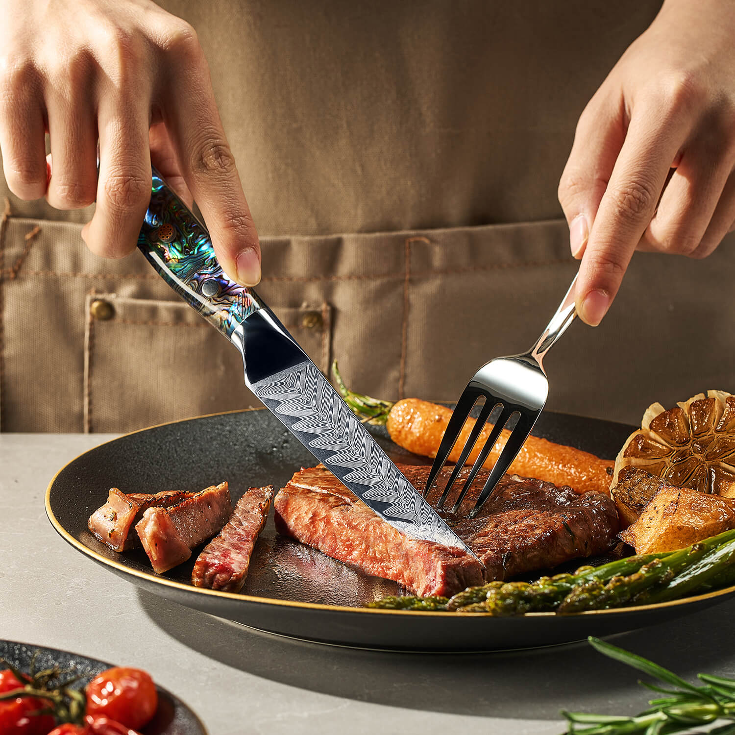 Person cutting into a plate of cooked meat and vegetables with a decorative knife and fork.