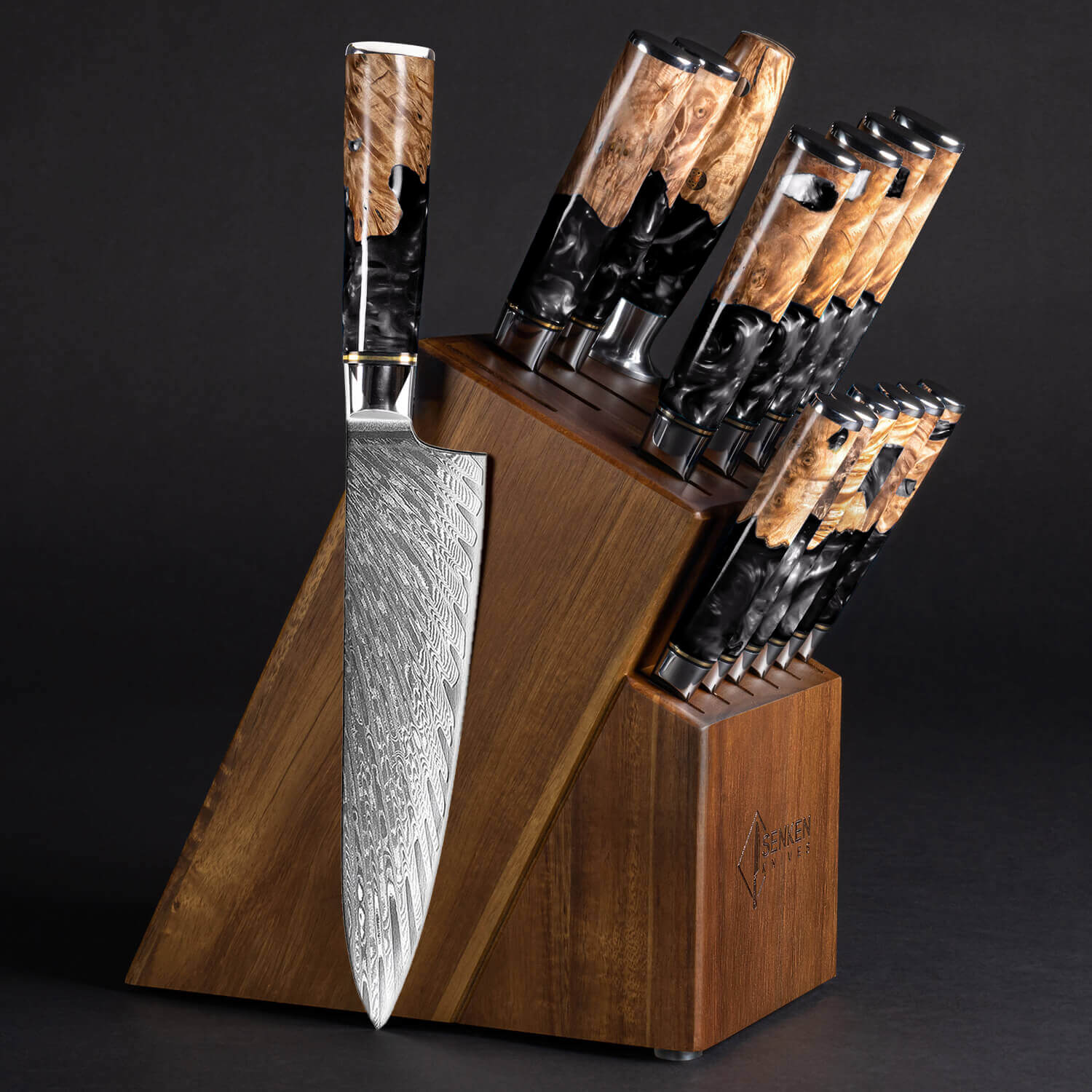 Senken Black Tsunami 16-Piece Knife Block Set featuring Japanese VG10 Damascus steel knives with black resin burl wood burl handles in a dark acacia wood block.