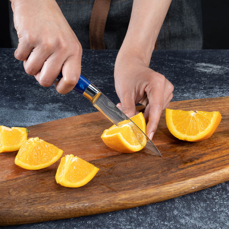 Cerulean Blue Resin Paring Knife by Senken Knives Slicing Oranges