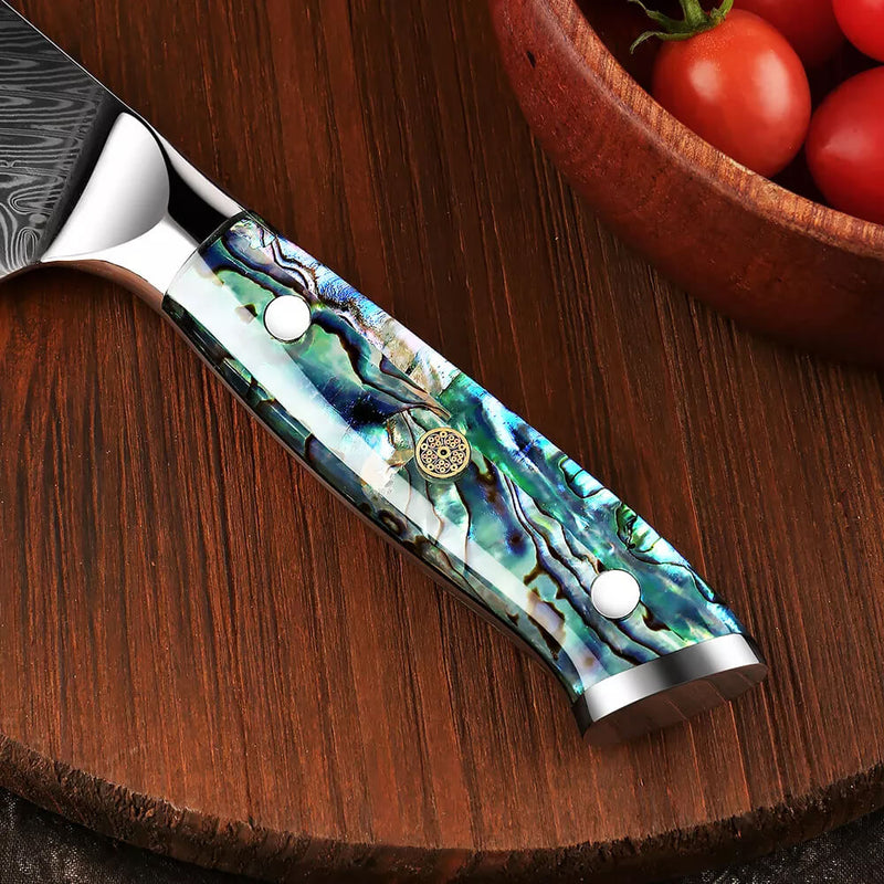 Umi Damascus Steel Japanese Cleaver Abalone Shell Handle Closeup on Wood